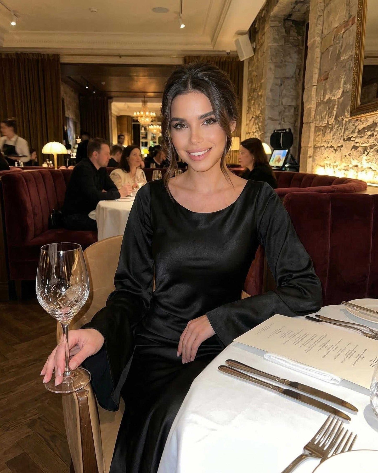 Stylish woman in Hive Maxi Dress, black satin, elegant for formal dining, by RAMBLION.