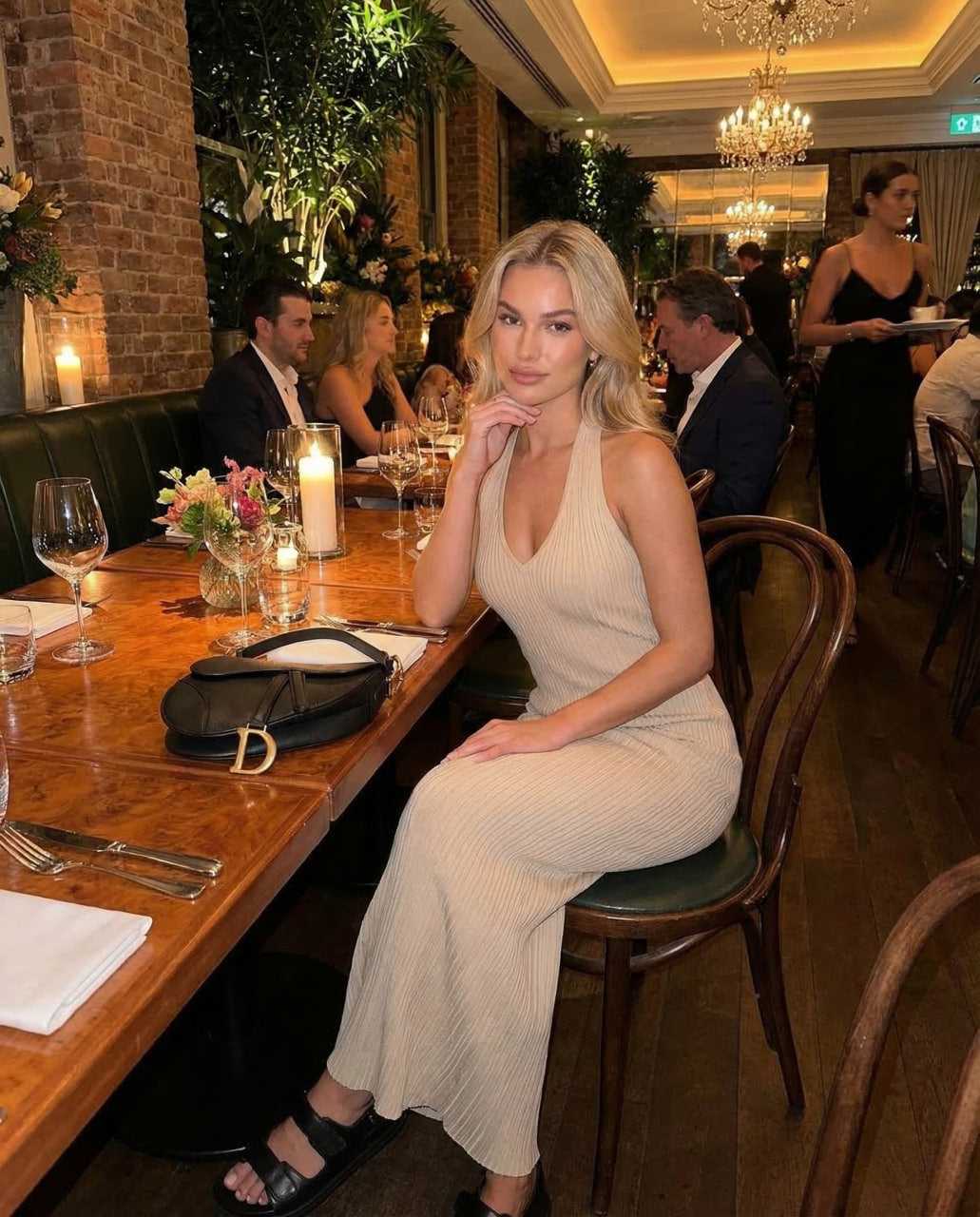 Nira Maxi Dress in a stylish setting, showcasing its elegant V neck design, perfect for sophisticated dining occasions.