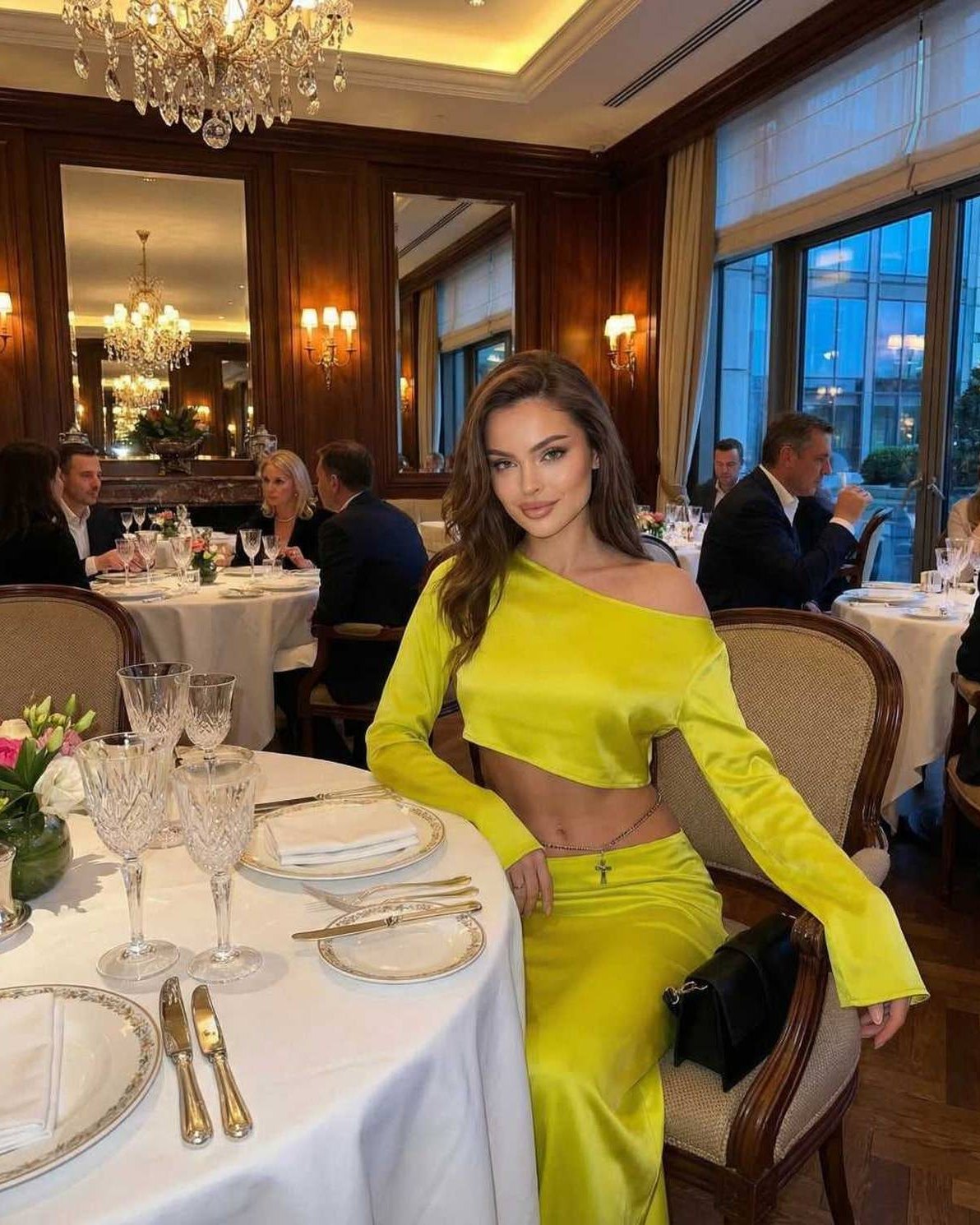 Lana Midi Dress in vibrant yellow at a fine dining setting, showcasing elegant style and comfort, by RAMBLION.