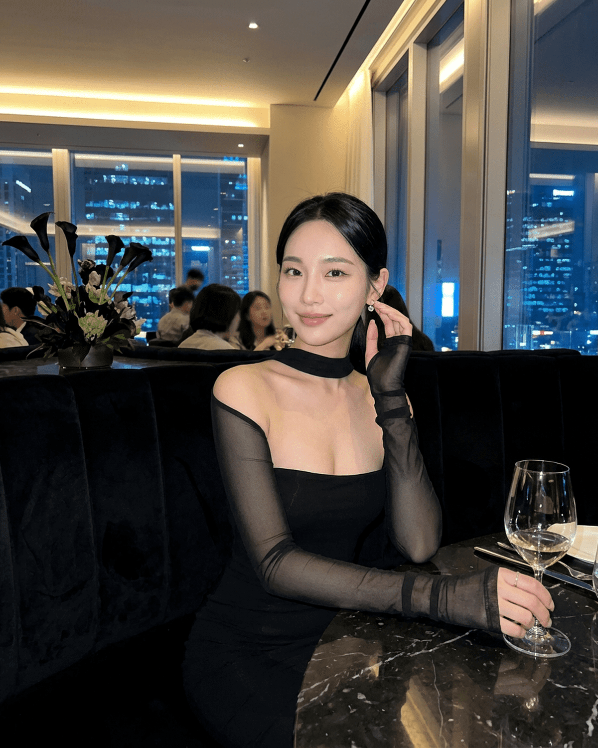 Elegant woman wearing Reda Midi Dress with long sheer sleeves, high neck, perfect for a night out at a chic venue.