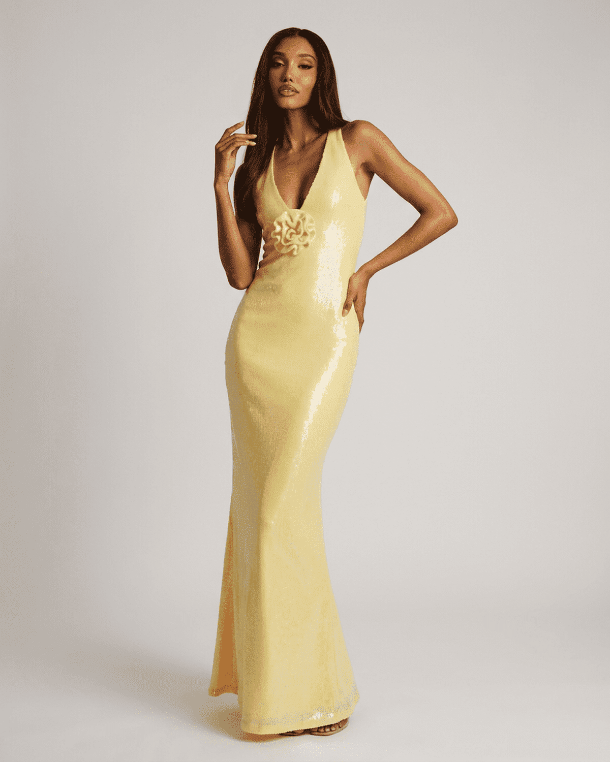Solara Maxi Dress in yellow with backless V-neck and floral sequin detail by RAMBLION.