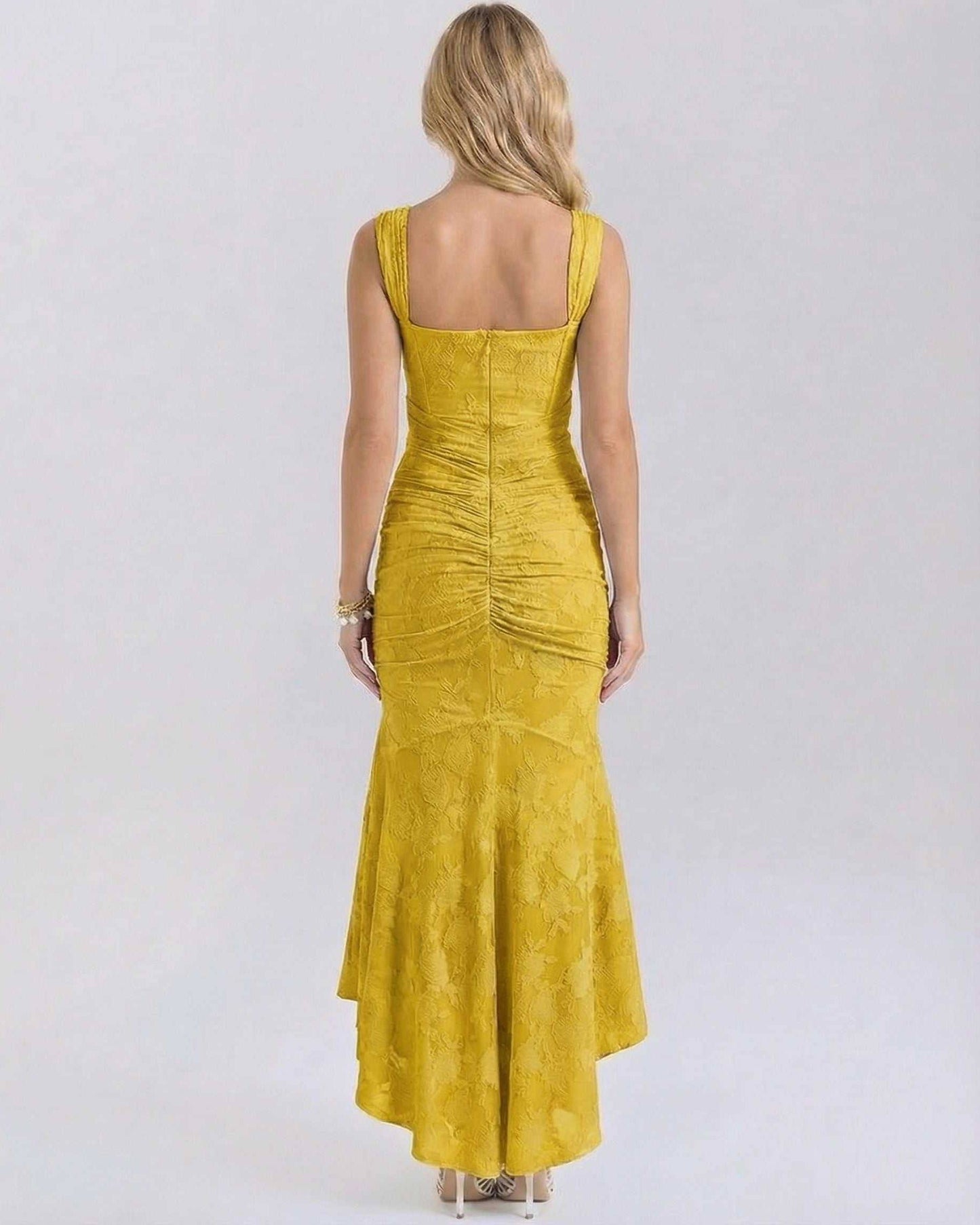 Back view of the Alma Maxi Dress in yellow, showcasing its elegant silhouette and luxurious jacquard fabric by RAMBLION.