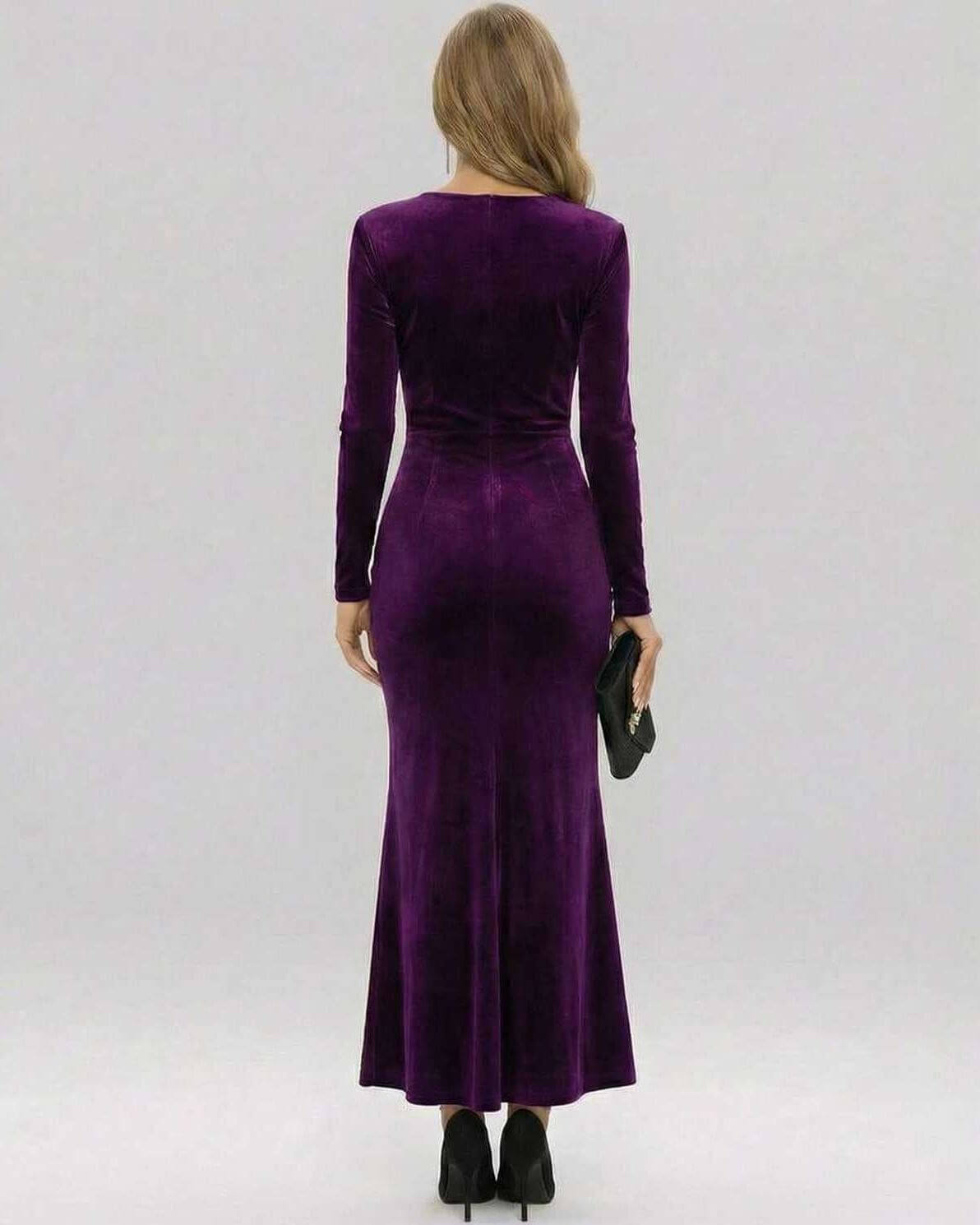 Back view of the Amara Maxi Dress in regal purple velvet, showcasing its elegant silhouette and long sleeves.