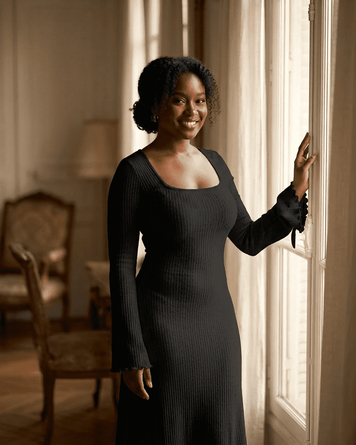 Arlo Maxi Dress worn by a smiling woman, showcasing its chic square neckline and ribbed texture in black, perfect for elegant occasions.