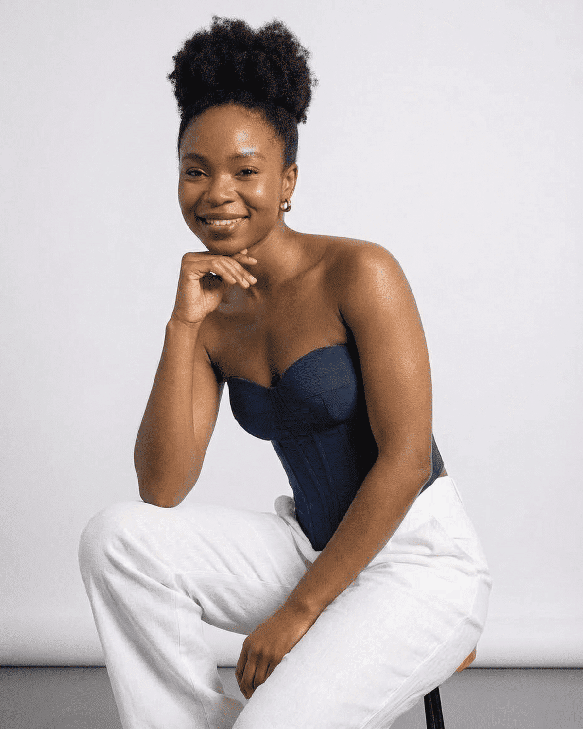 Model wearing Atlas Corset Top, a faux denim cup bustier, showcasing a structured slim design.