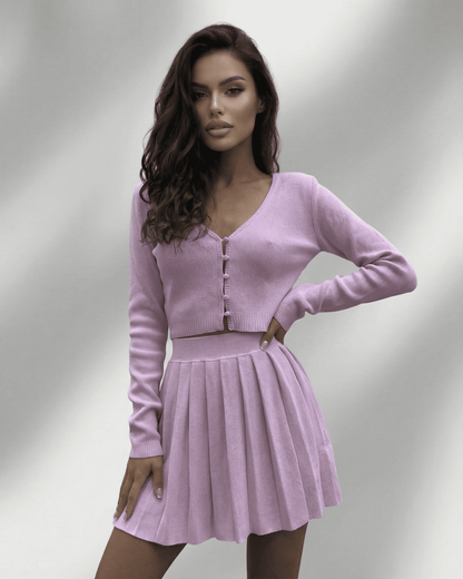 Bianca Set in pink mini dress with V neck, featuring a cropped cardigan and pleated skirt, by RAMBLION. Perfect for stylish occasions.