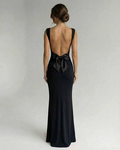 Biot Maxi Dress showcasing a backless design with a bow, elegant black satin perfect for formal occasions by RAMBLION.