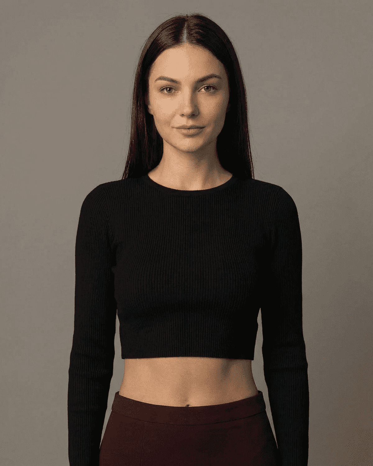 Merlot Maxi Skirt model wearing high-waisted black crop top with long sleeves and minimalist style.