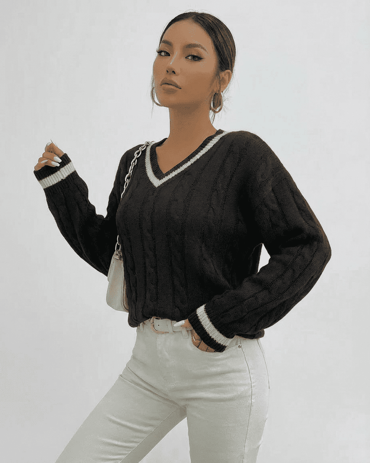 Pia Sweater by RAMBLION in black, featuring cable knit texture, V-neck design, perfect for stylish layering.