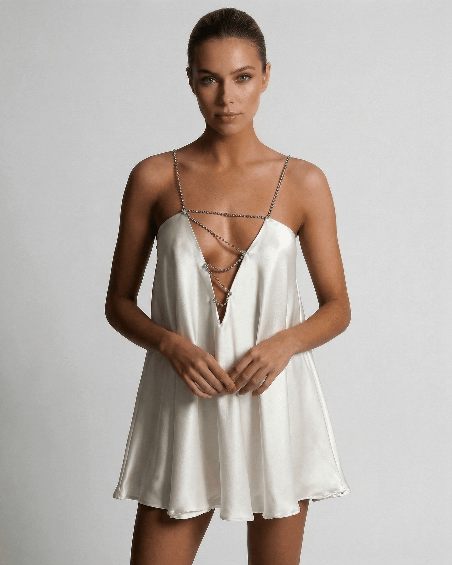 Brno Mini Dress by RAMBLION, white satin V-neck mini dress perfect for summer nights and cocktail gatherings, exudes elegance.