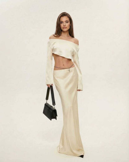 Cabo Midi Dress in beige satin, featuring a slash neckline, perfect for elegant occasions. By RAMBLION.