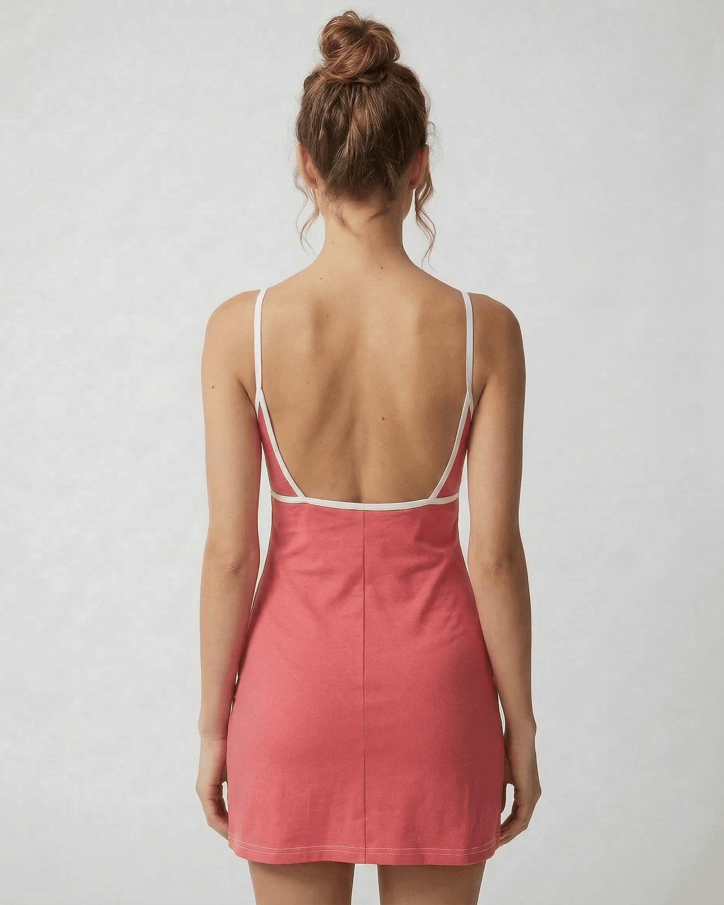 Calo Mini Dress back view showing round neck, playful patchwork design, and soft polyester blend by RAMBLION.