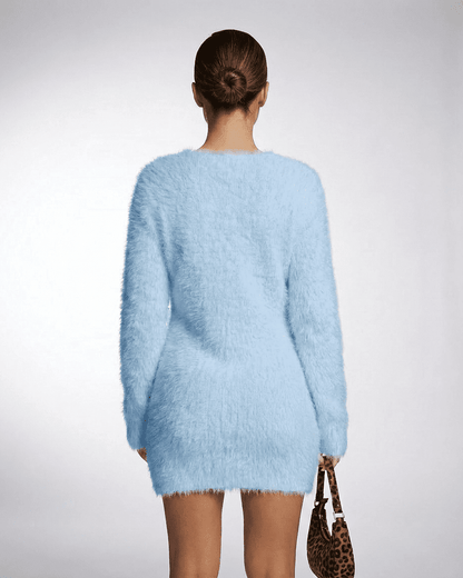 Model wearing the Celeste Sweater in sky blue, showcasing its fuzzy plush knit texture and V-neck design.