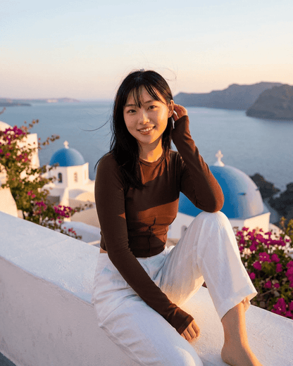 Cocoa Corset Top model in Santorini, showcasing RAMBLION's stylish long sleeve jersey corset crop.