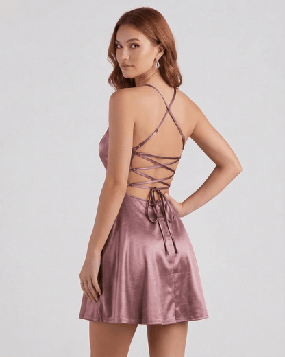 Dara Mini Dress in soft pink satin with elegant strappy back; perfect for romantic occasions by RAMBLION.
