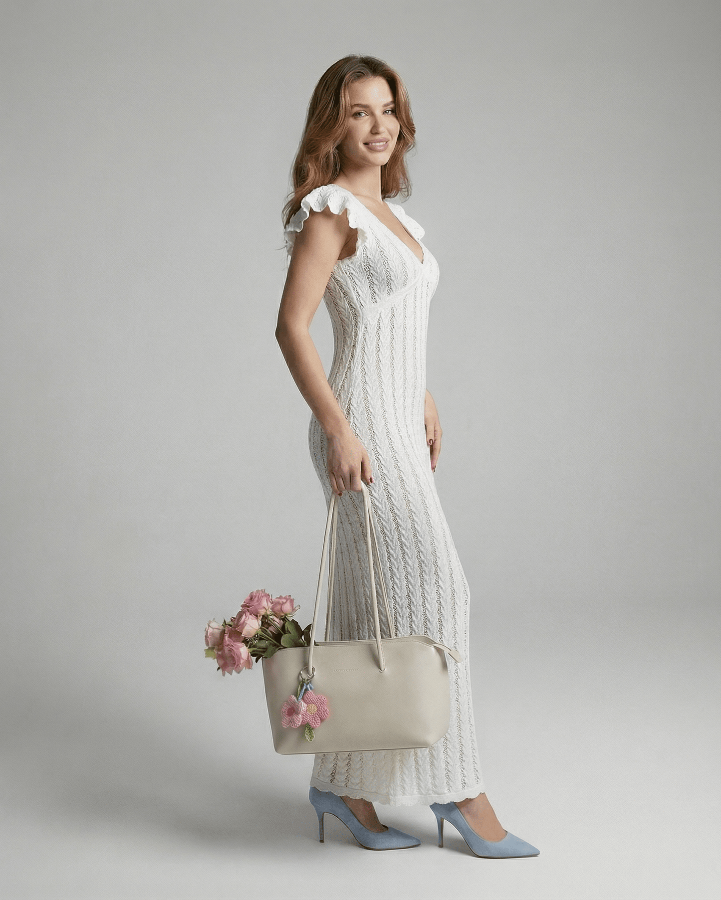 Model wearing Deva Maxi Dress, a white ankle-length cotton dress by RAMBLION, featuring a V-neck and ruffles, perfect for elegant occasions.