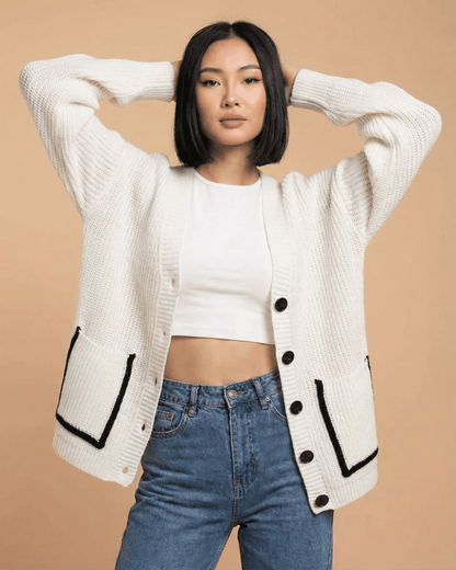 Elara Cardigan worn by a model, showcasing its loose fit, V-neck, and color block design.