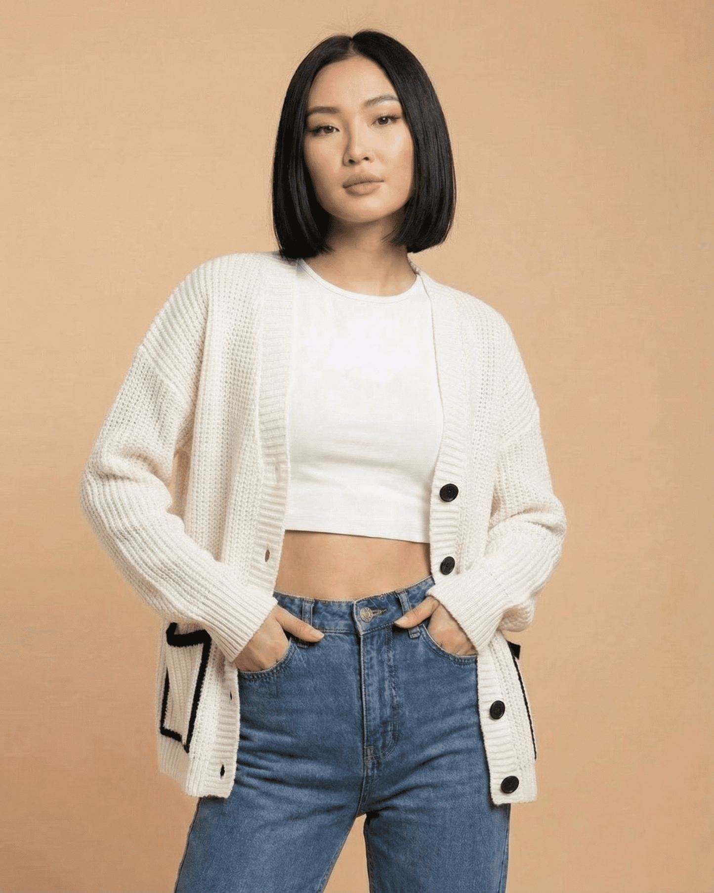 Elara Cardigan by RAMBLION worn by model, featuring a loose fit and classic V-neck design.