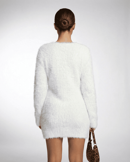 Back view of a model wearing the Elara Sweater in white, showcasing its plush texture and stylish design.