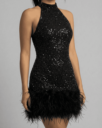 Elsa Mini Dress with black sequin overlay, halter neckline, and feather hem, perfect for glamorous events by RAMBLION.