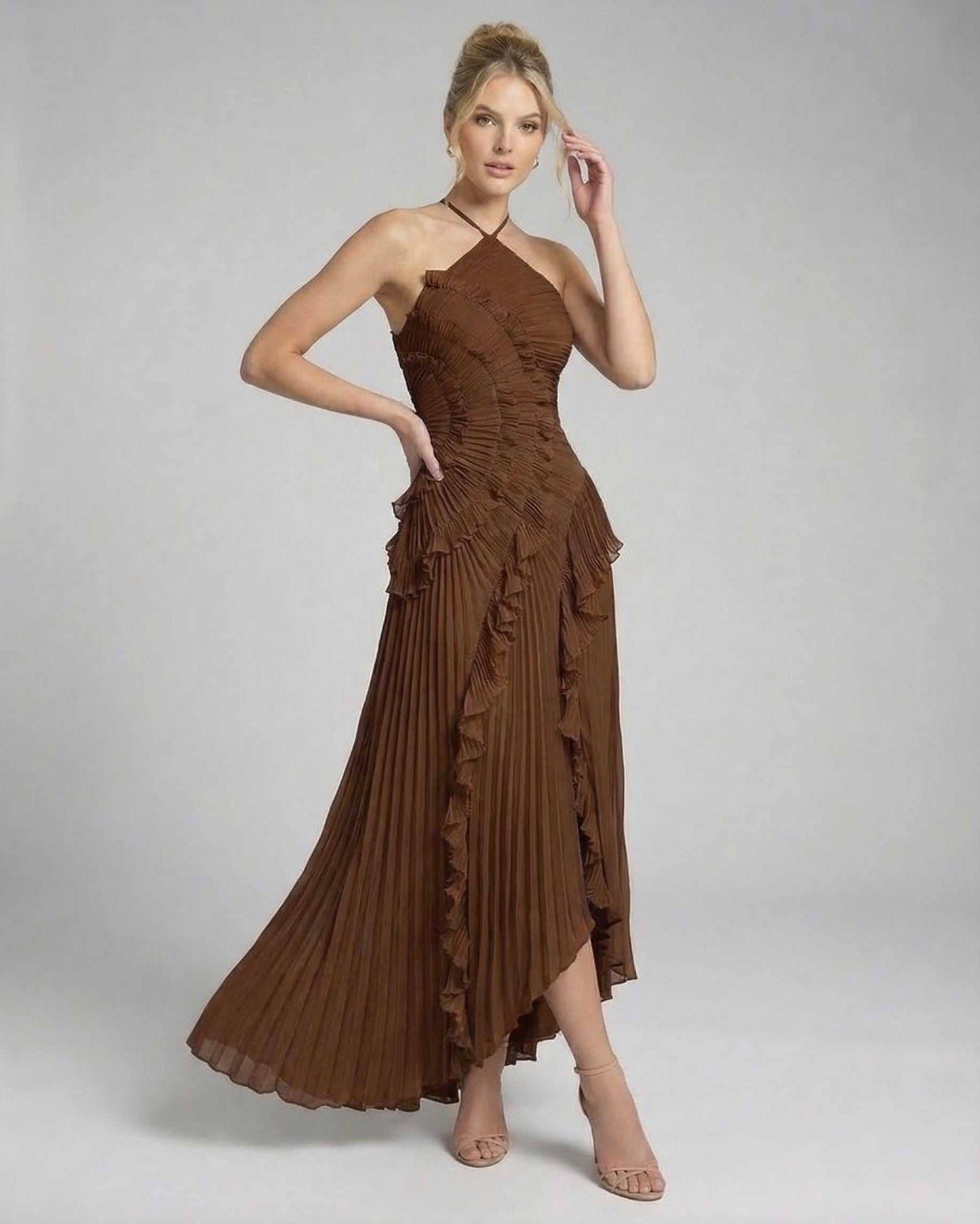 Fia Maxi Dress showcasing a luxurious brown halter neckline, pleated design, and ruffle details, ideal for elegant occasions.