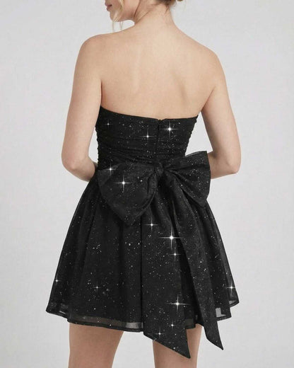 Gira Mini Dress by RAMBLION, black strapless A-line design with a bow, perfect for evening elegance.