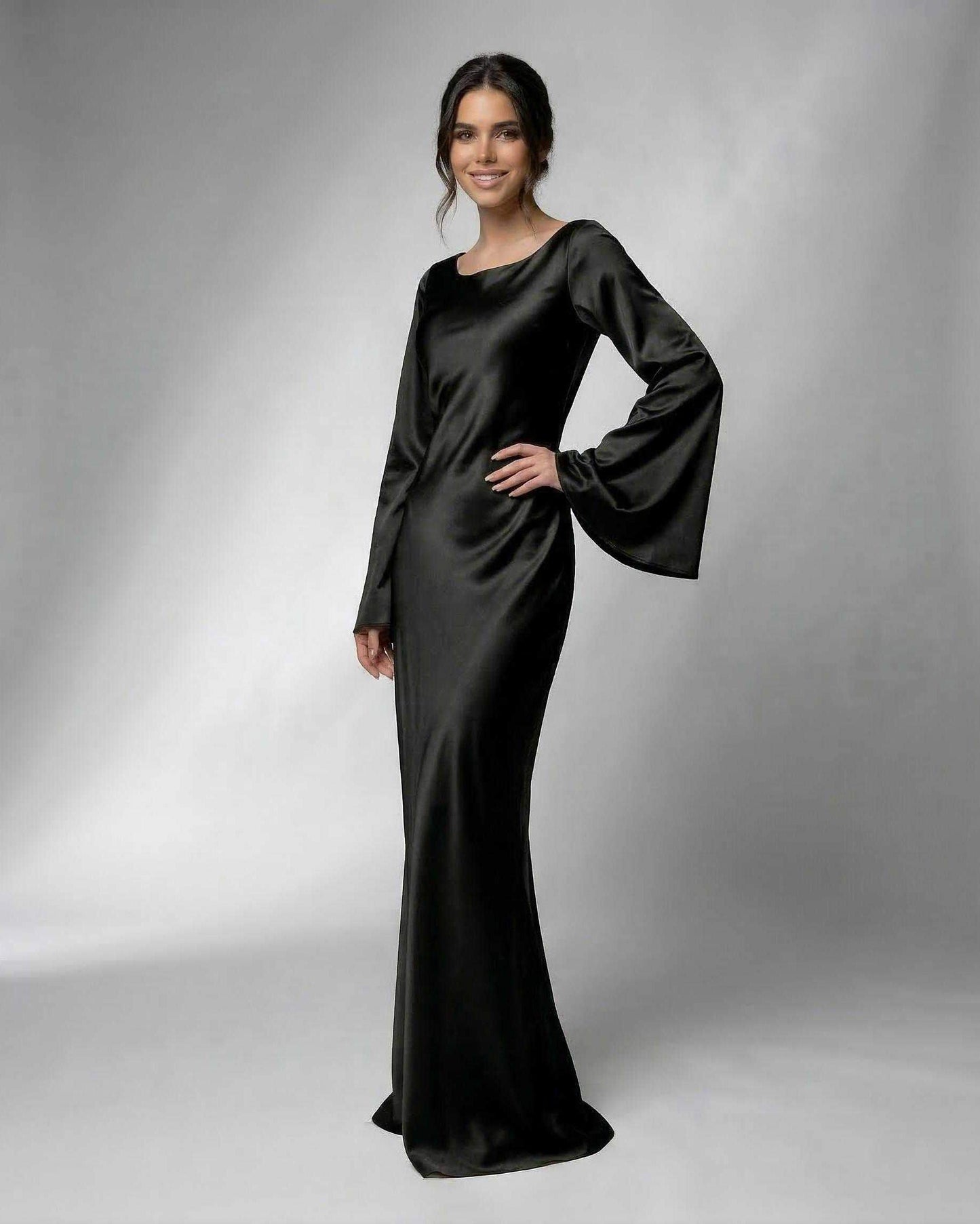 Hive Maxi Dress in black satin, featuring boat neck and long bell sleeves, perfect for formal occasions by RAMBLION.