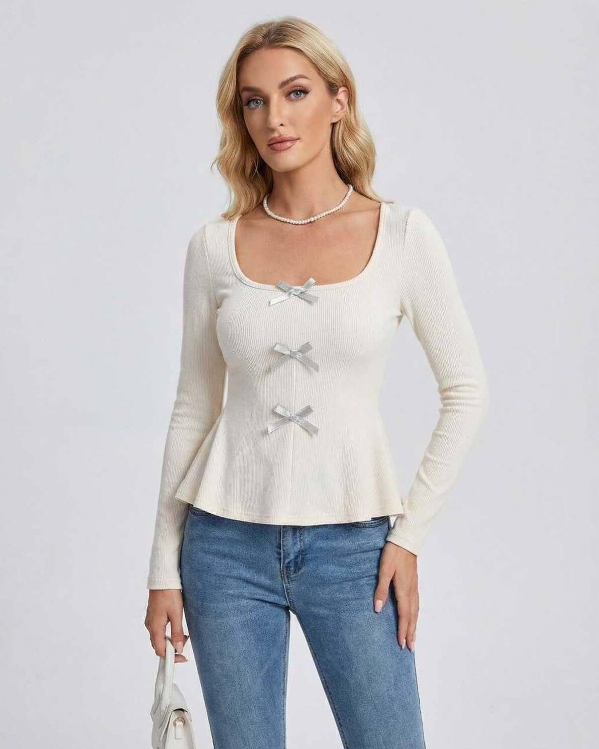 Holl Pullover by RAMBLION, beige ribbed knit top with square neck, long sleeves, and bow details, perfect for stylish casual wear.