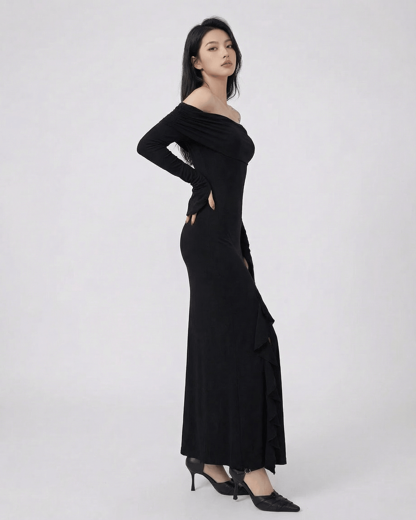 Isis Maxi Dress from RAMBLION, elegant off-shoulder black dress with asymmetrical ruffle, perfect for special occasions.