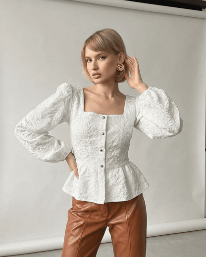 Ivory Corset Top by RAMBLION featuring a jacquard square neck and puff sleeves, styled with leather pants.