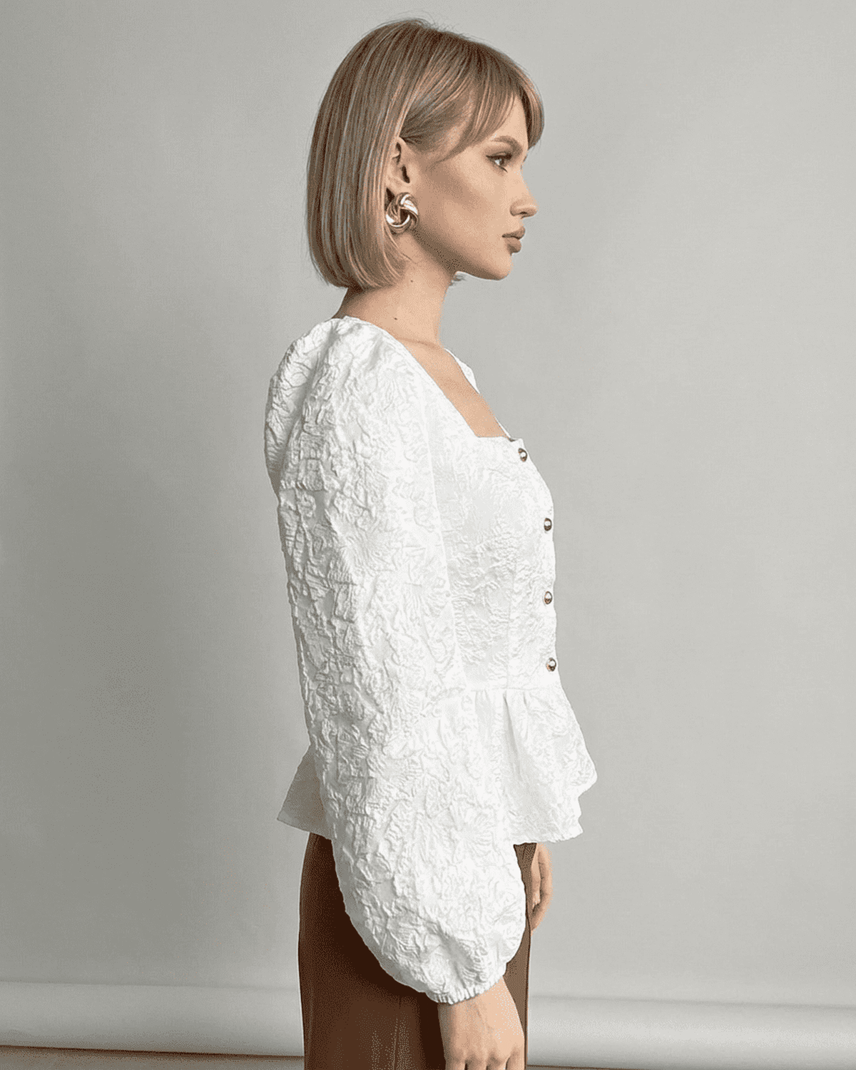 Ivory Corset Top by RAMBLION, featuring jacquard fabric and puff sleeves, showcasing a refined and elegant look.