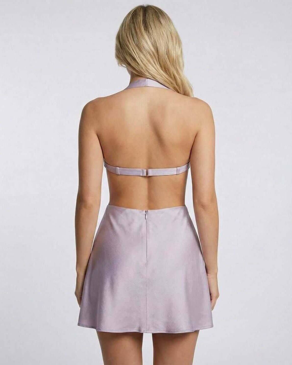 Back view of the luxurious Kara Mini Dress in purple satin, showcasing its A-line design and halter style by RAMBLION.