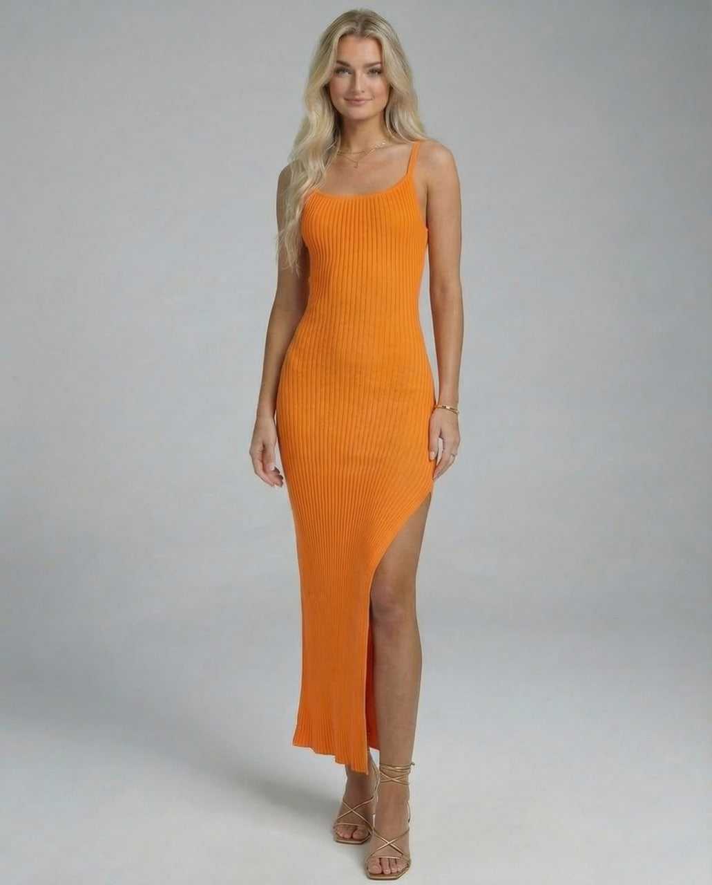 Model wearing the Klia Midi Dress, a vibrant orange midi-length dress with a stylish slash neckline.