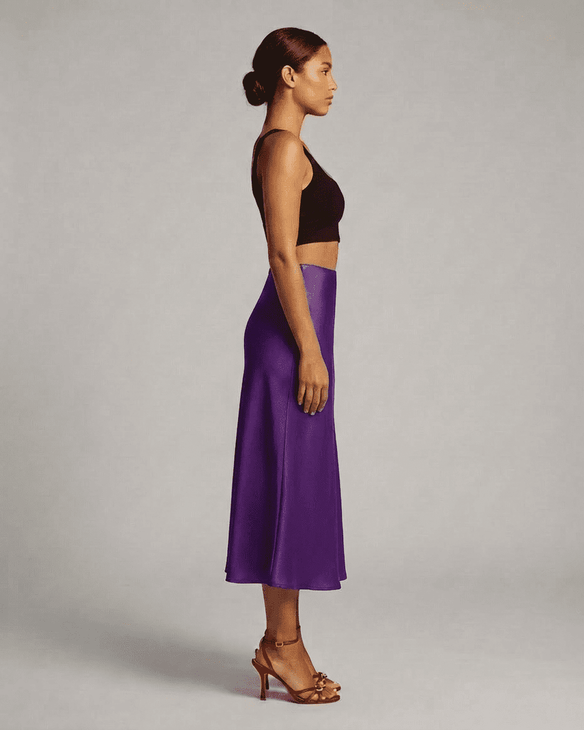 Amethyst Midi Skirt by RAMBLION showcased on a model, highlighting its elegant silhouette and rich purple color.