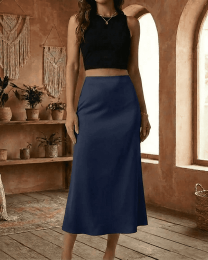 Astra Midi Skirt by RAMBLION in deep navy blue, satin mermaid style, showcasing smooth elegance and modern design.