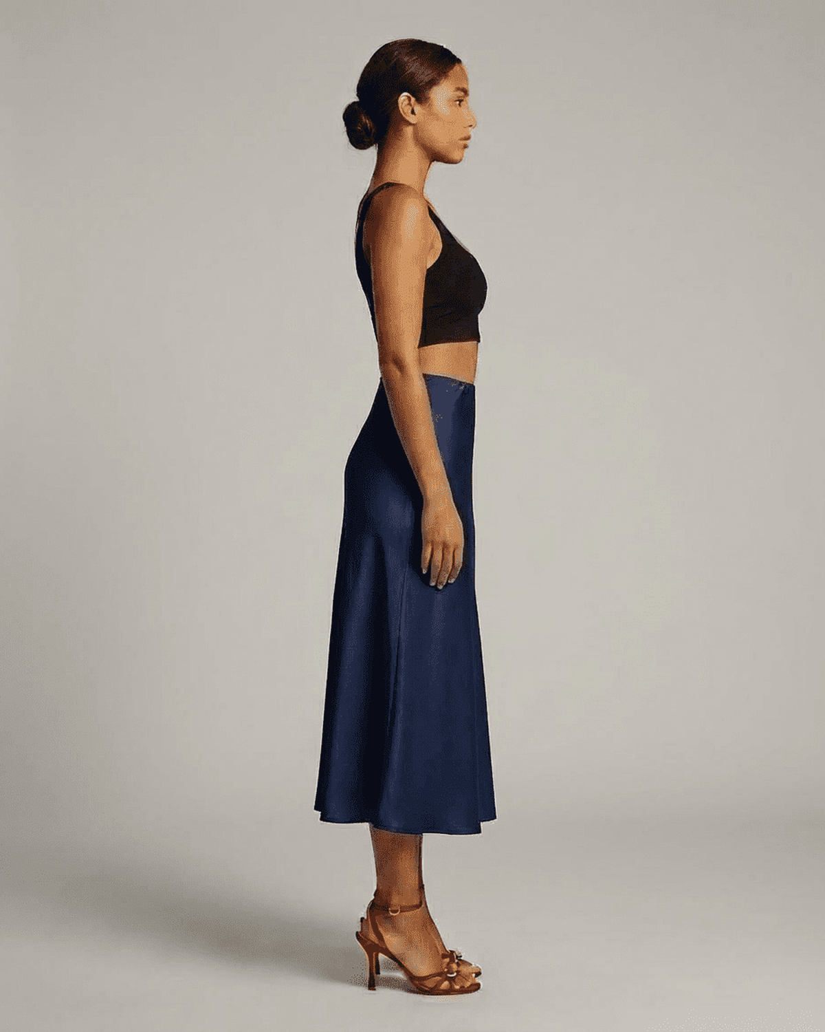 Astra Midi Skirt by RAMBLION in deep navy blue, showcasing elegant mermaid silhouette from side view.