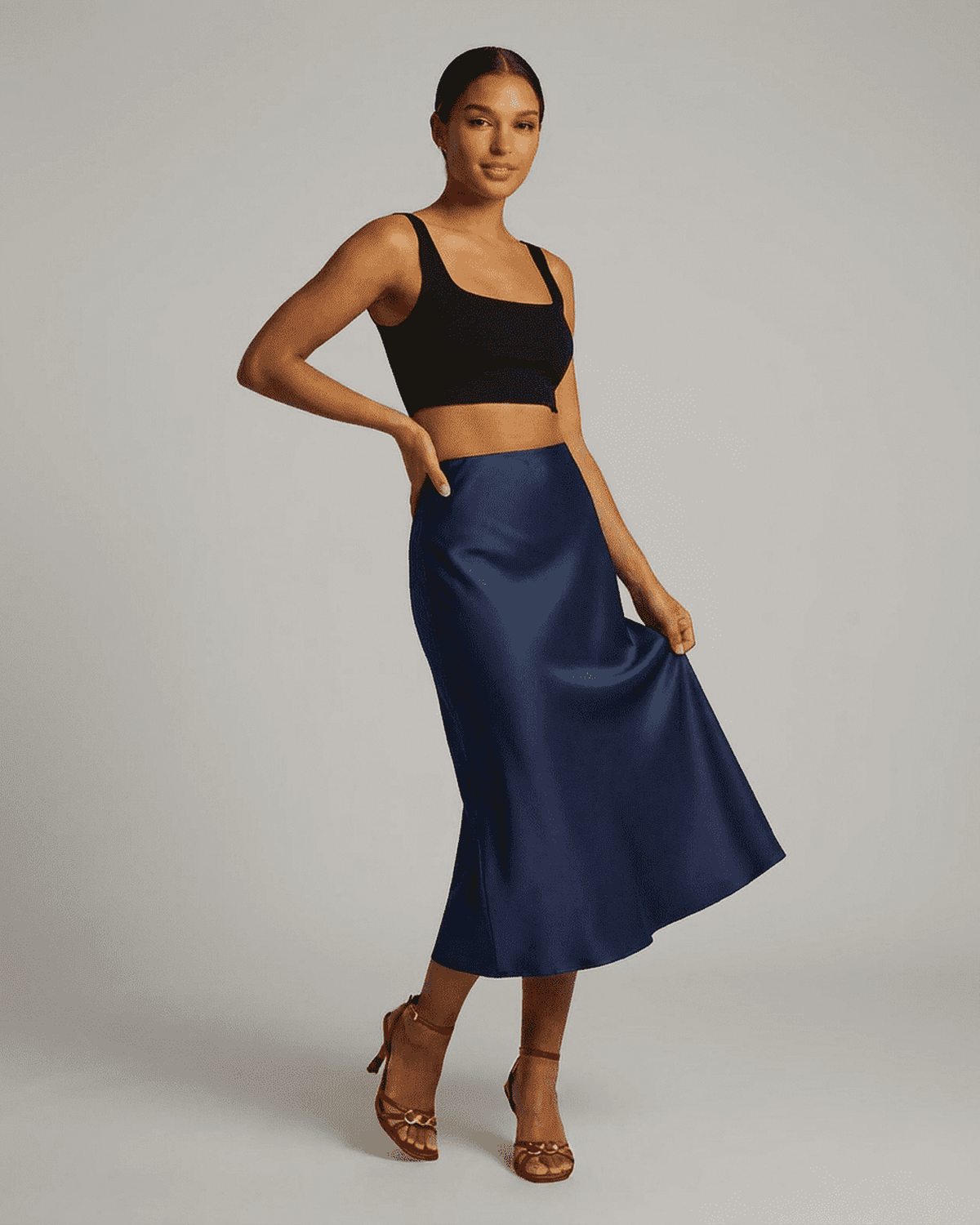 Astra Midi Skirt by RAMBLION, elegant satin mermaid midi skirt in deep navy blue, showcasing a sleek silhouette.