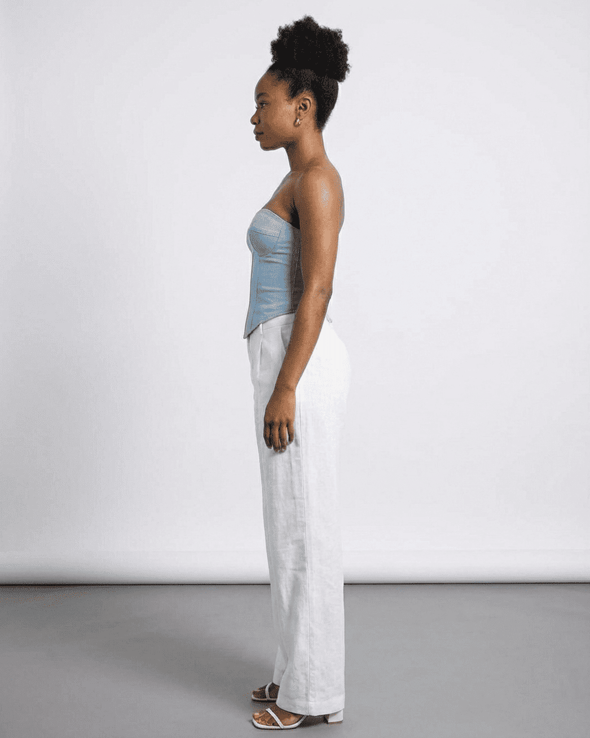 Denali Corset Top by RAMBLION, showcasing a blue faux denim cup bustier in a side profile view.
