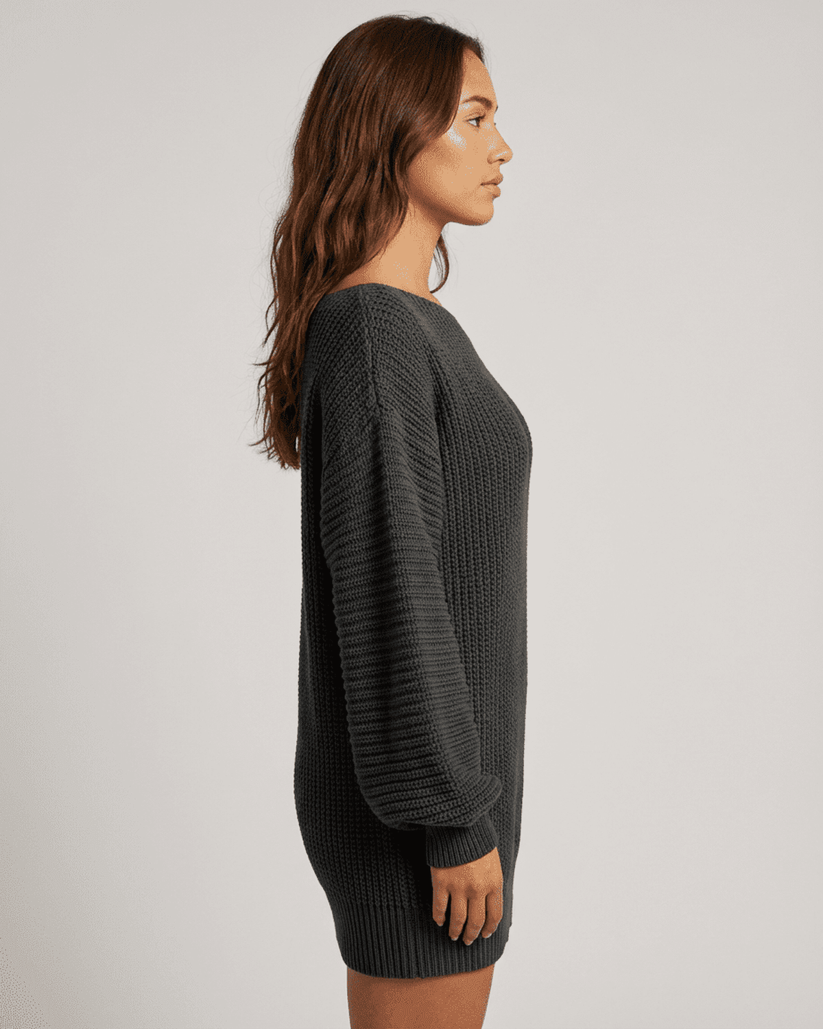 Ember Mini Dress by RAMBLION, showing side view of ribbed knit off-the-shoulder lantern sleeve in charcoal.