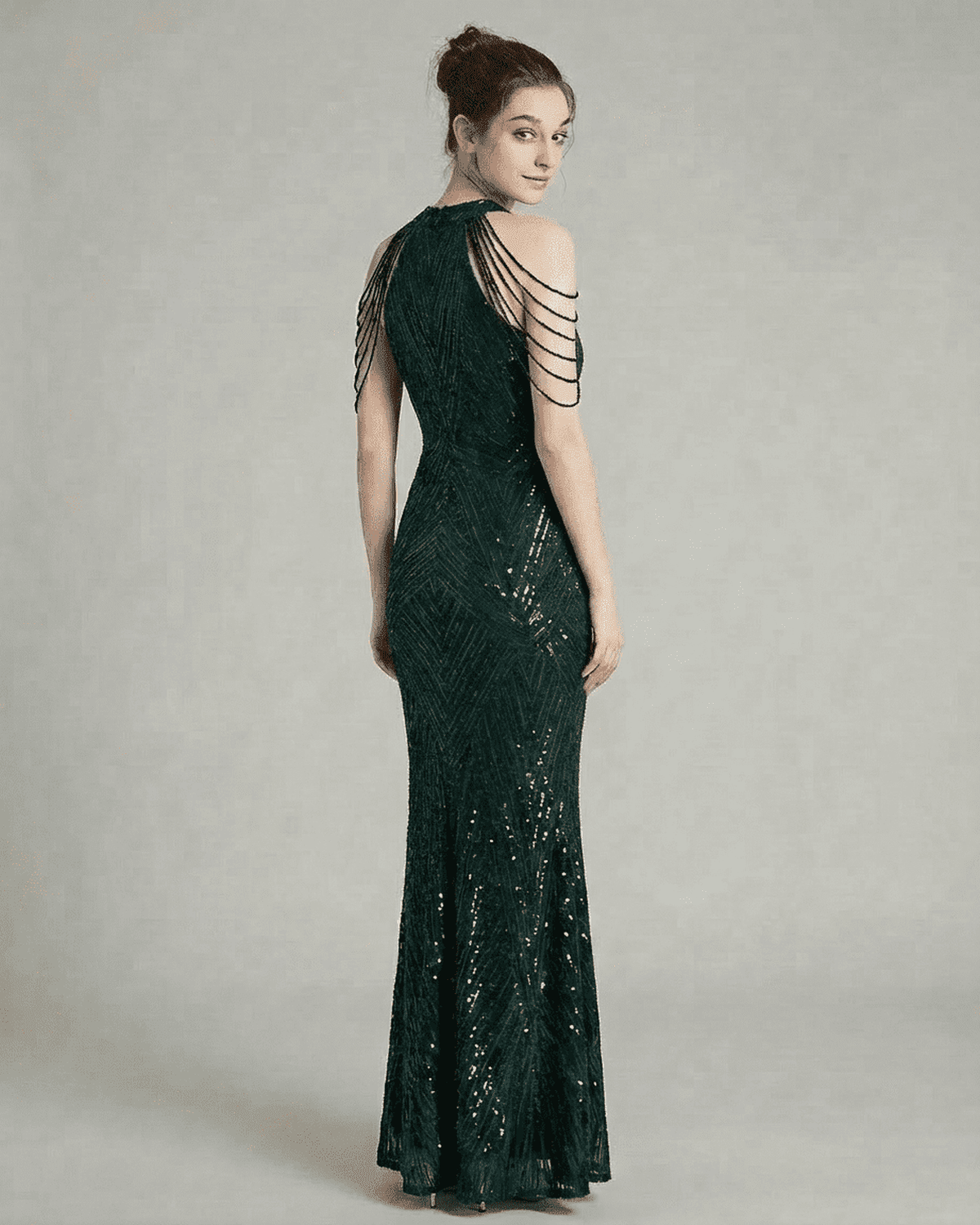 Emerald Maxi Dress by RAMBLION features a striking back design with beaded shoulder drapes, embodying elegance and sophistication.