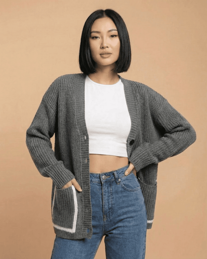 Linden Cardigan - Relaxed V-Neck Color Block Knit model wearing a stylish gray sweater with a button-front.