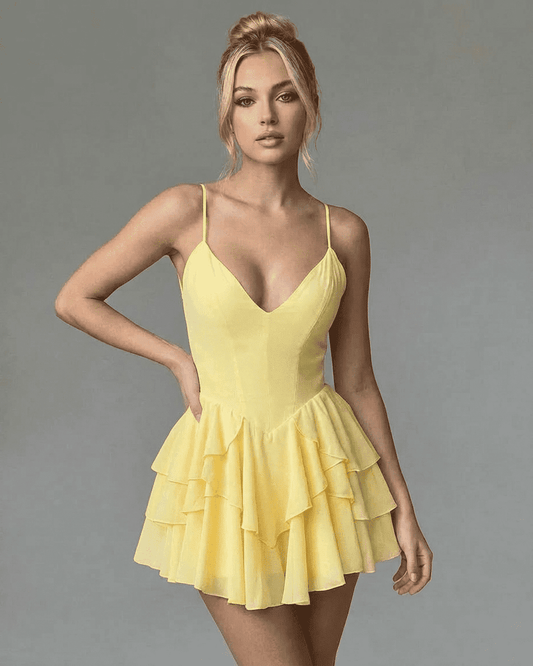 RAMBLION Marigold Mini Dress showcasing a V-neck, spaghetti straps, and a tiered ruffle skirt in vibrant yellow.