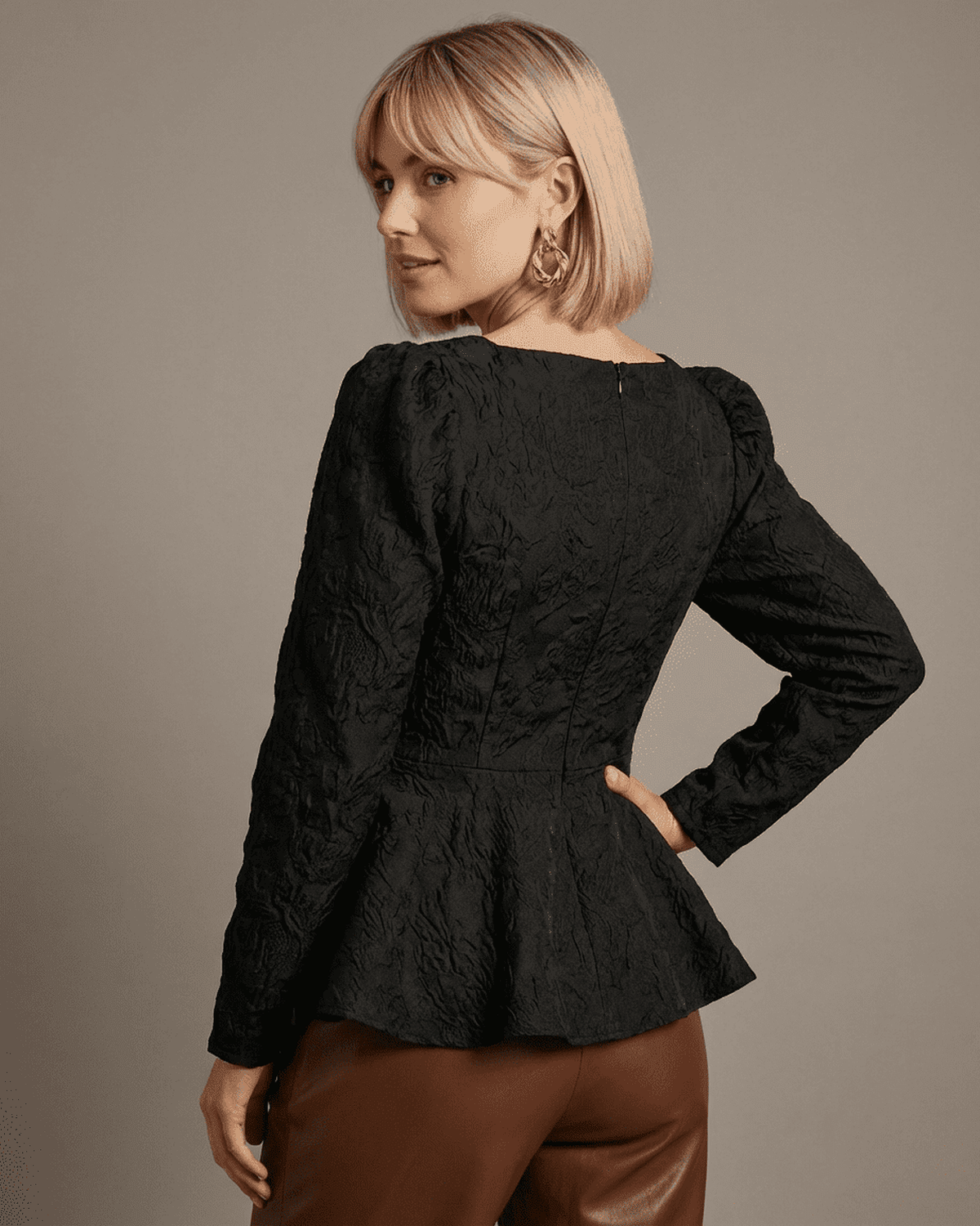 Elegant back view of Noir Corset Top by RAMBLION, featuring structured jacquard fabric and puff sleeves.