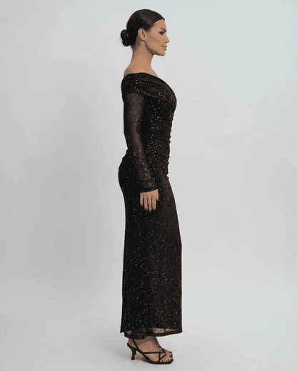 Noir Maxi Dress by RAMBLION - Elegant off-the-shoulder mesh gown with sequins, showcasing a side profile.
