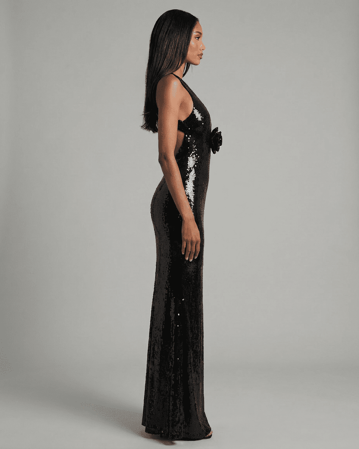 Noiré Maxi Dress from RAMBLION featuring a backless V-neck silhouette and striking floral sequin detail.