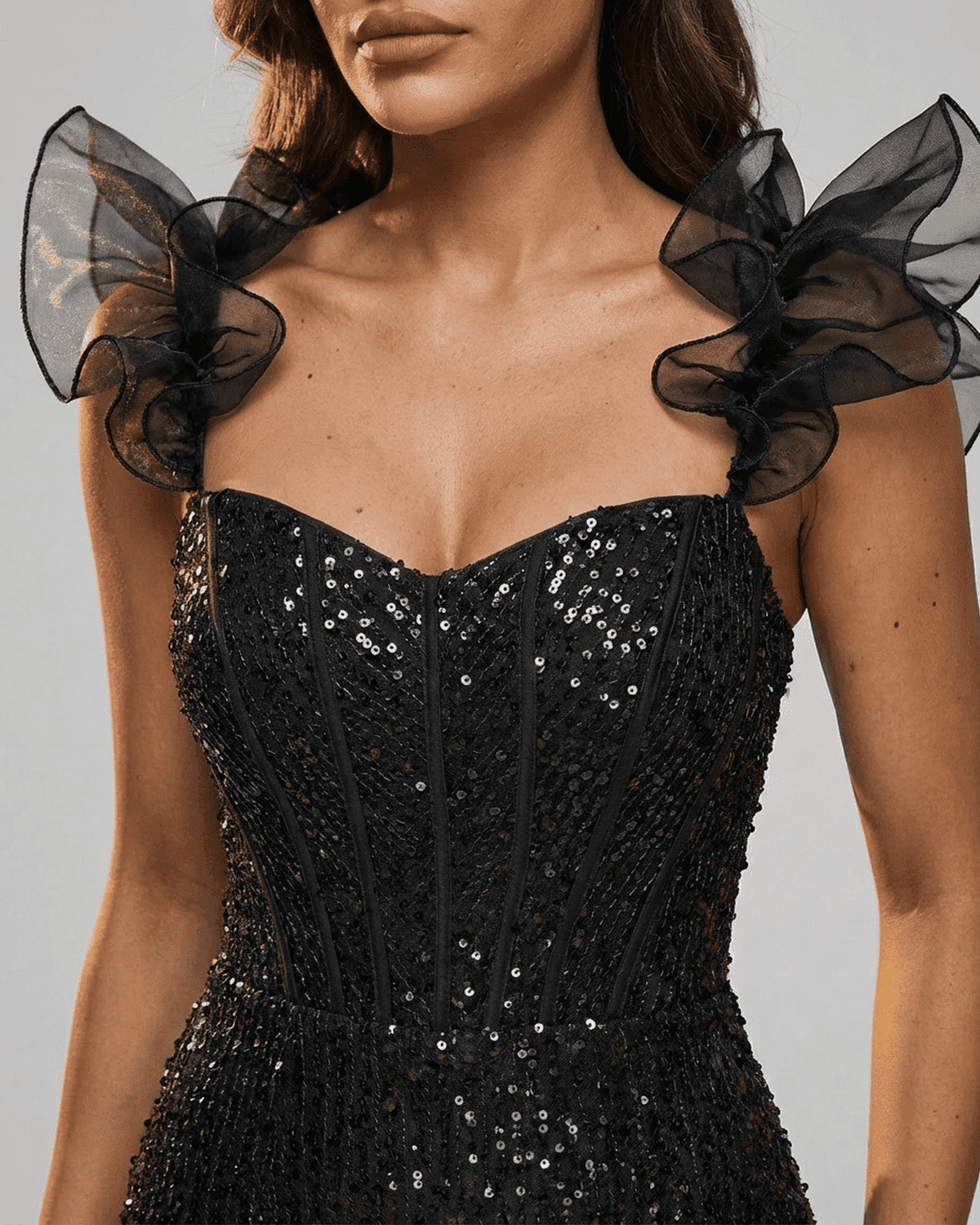 Obsidian Mini Dress by RAMBLION featuring black sequin off-the-shoulder design and ruffle sleeves.