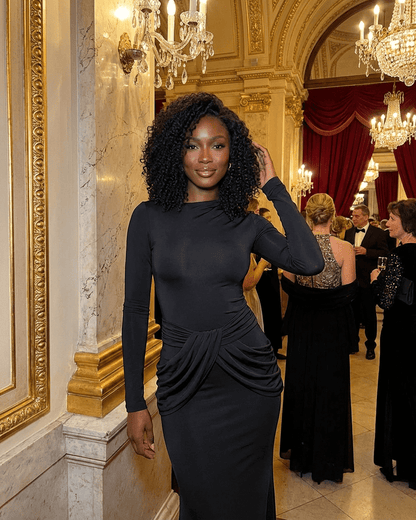 Model wearing the Orion Maxi Dress by RAMBLION, showcasing its elegant long sleeve design and ruched waist detail.