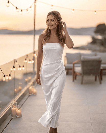 RAMBLION Pearl Maxi Dress showcases a strapless tube silhouette with subtle ruched texture against a sunset backdrop.