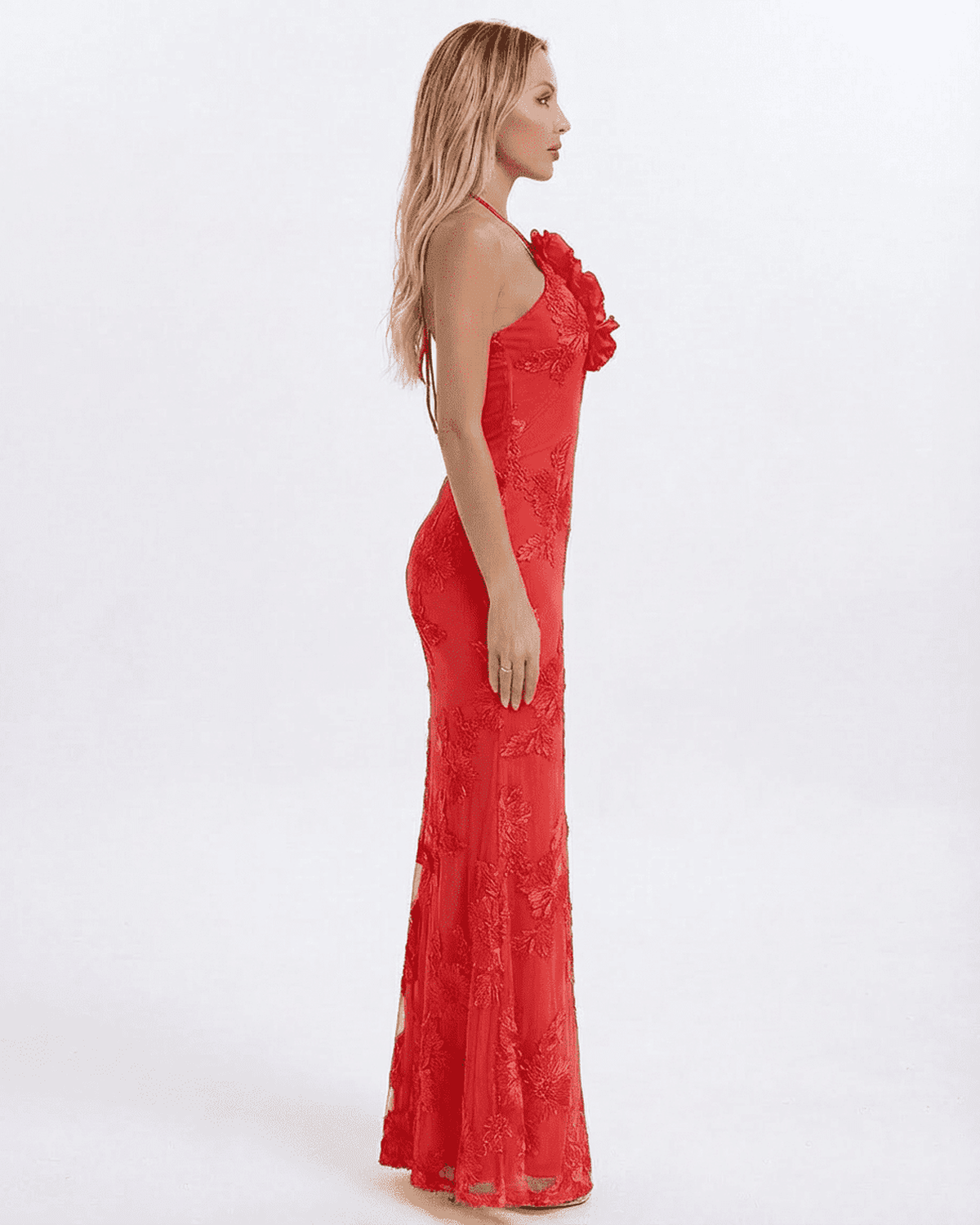 Rosalia Maxi Dress by RAMBLION, featuring a side view of a sleek red halter neck design with 3D floral appliqué detail.