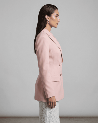 Side view of model wearing the elegant Rosalie Blazer by RAMBLION, showcasing its tailored silhouette in pink.